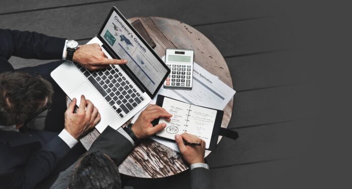 laptop and diary writing a business plan