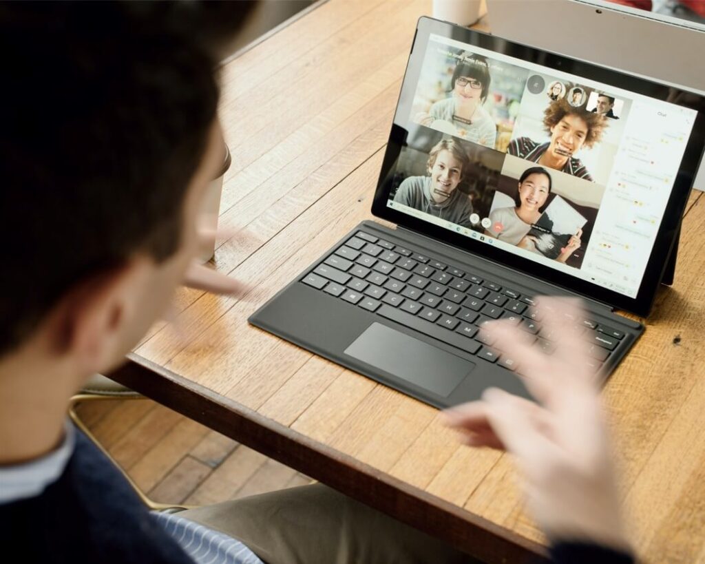 boy communating remotely in a laptop with his remote teams