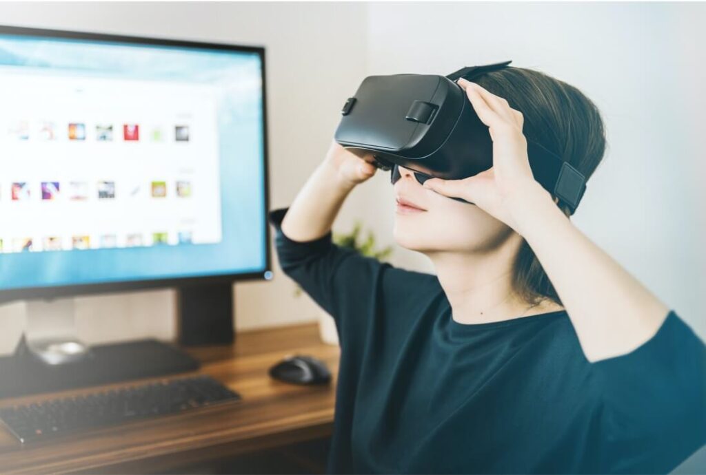 boy experiencing virtual reality infront of laptop
